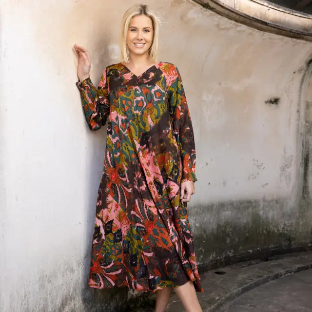 A woman in a colourful, patterned Orientique dress.