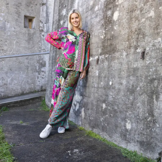 Woman in a colourful Orientique patterned outfit.